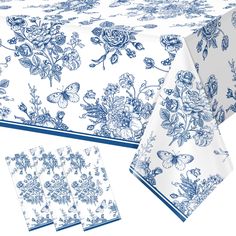 a blue and white table cloth with floral designs on the top, along with matching napkins