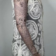 a woman with tattoos on her arm and shoulder