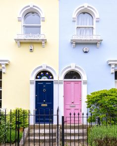 two colorful doors are in front of a house