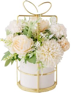 a white and gold flower arrangement in a metal container with a bow on the top