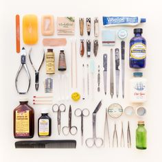 an assortment of medical items are displayed on a white surface, including scissors and other things