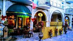 the outside of a restaurant with tables and chairs