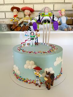 a birthday cake with toy figures on it