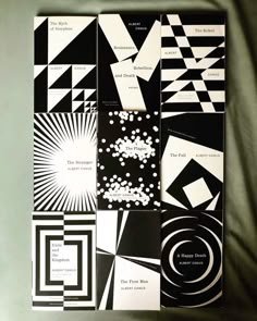 several black and white designs on a sheet of paper