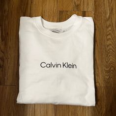 Brand New! Never Worn! Long Sleeve White T Shirt 100% Cotton Calvin Klein Brand Calvin Klein Crew Neck Top With Logo Print, Calvin Klein Logo Print Crew Neck Top, Calvin Klein Relaxed Fit Logo Print Top, Calvin Klein White T-shirt For Streetwear, White Short Sleeve Sweatshirt With Logo, Calvin Klein Long Sleeve Logo Print Tops, Calvin Klein Long Sleeve Tops With Logo Print, White Calvin Klein Crew Neck T-shirt, Calvin Klein White Crew Neck T-shirt