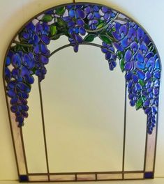 a stained glass window with purple flowers on it