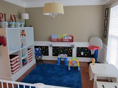 a child's playroom with toys, bookshelves and rugs on the floor