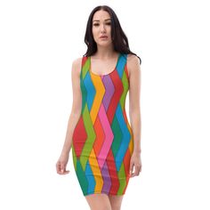 a woman in a multicolored dress is posing for the camera with her hands on her hips