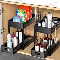 two black trays filled with different types of toiletries and personal care products on top of a wooden cabinet