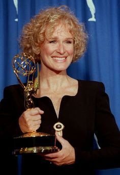 the actress poses with her award for outstanding performance