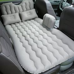 an inflatable car seat with pillows on the front and back seats is shown