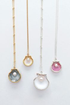 three different necklaces with pearls on them