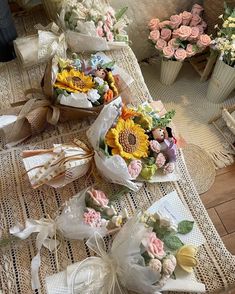 some flowers are sitting on a table next to other vases with flowers in them