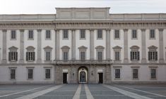 a large white building with many windows and doors