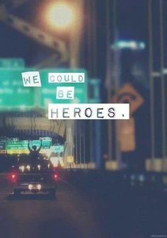 a car driving down a street at night with the words we could be heros written on it