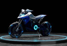 a futuristic motorcycle is shown on display with blue lights around the wheel and tire hubs