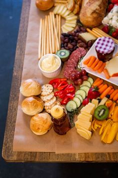 a wooden table topped with lots of different types of food