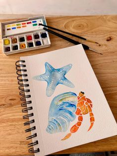 a watercolor drawing of two starfishs and a shell on a wooden table