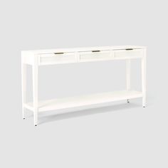 a white console table with two drawers on one side and an open shelf at the top