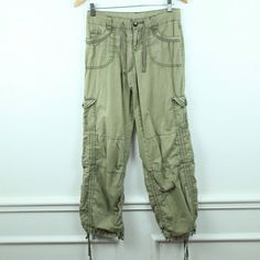 Vintage 90s/Y2K Unionbay cargo pants size 3. They are 100% cotton. They are a lightweight woven fabric for spring/summer. missing buttons on back pockets, holes on pockets where heavy buttons are attached, see photos. There are no stains. Please see all photos for condition and check the measurements for size. Waist 30" Hip 38" Rise 8 3/4" Inseam 31" Leg Opening 18" AA Spring Military Style Cotton Cargo Jeans, Mid-rise Cotton Parachute Pants With Pockets, Spring Military Wide Leg Cargo Pants, Spring Military Wide-leg Cargo Pants, Spring Military Style Wide Leg Cargo Pants, Y2k Style Khaki Bottoms For Spring, Spring Y2k Khaki Bottoms, Military Style Cargo Jeans For Spring, Spring Military Style Parachute Pants With Cargo Pockets