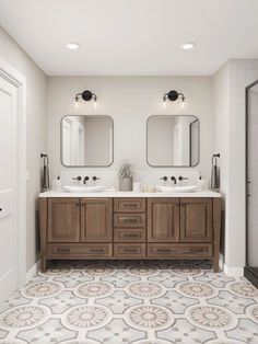 a large bathroom with two sinks and mirrors