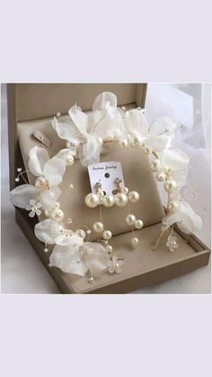 a box that has some pearls and other items in it on top of a table