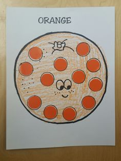 an orange drawing is shown on top of a piece of paper with the words orange