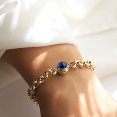 14K Gold Evil Eye Rolo Chain Bracelet Materials & Specifications:  - 14k gold rolo chain bracelet - Lobster clasp closure - Chain thickness is about 6.8mm - Chain links are hollow - Available in 1, 2 or 3 evil eye charm options - The dimensions of a single evil eye charm are 10.35mm x 11.75mm - The dimensions of 2 and 3 evil eye charms are 10.07mm x 10.77mm Available in 4 different chain lengths: 6.7in (17cm), 7in (18cm), 7.5in (19cm), and 7.9in (20cm) As with all of our pieces, this item is han Charm Bracelet With Solid Links As A Gift, Round Rolo Chain Bracelet As A Gift, Round Rolo Chain Bracelet Gift, Gift Rolo Chain Bracelet Round Shape, Everyday Gold Bracelet With Birthstone, Gift Rolo Chain Bracelet, Formal Gold Bracelets With Birthstone, Round Birthstone Bracelets For Everyday, Round Rolo Chain Charm Bracelet As Gift