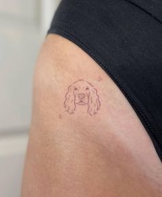 a dog's head is shown on the back of a woman's thigh