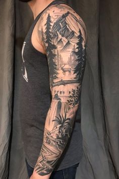 a man's arm with mountains and trees on it