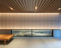 an empty room with wooden slats on the ceiling and benches in front of it