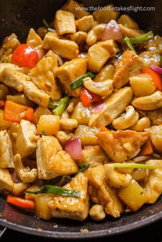 chicken and vegetable stir fry in a wok