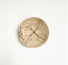 a woven basket with lines on the bottom and sides, sitting on a white surface