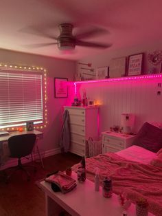 a bedroom with pink lights on the walls