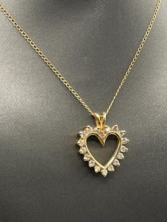 A beautiful ladies classic Diamond heart pendant designed and crafted in 14 karat solid yellow gold.  Set with 18 round dazzling white Diamonds framing the heart.  This one really sparkles and looks fabulous on your favorite chain! TDW: 1.00cts Weight:  3.7 grams Length:  1" Width: ¾" Our Price $595.00 Regularly Priced At $900.00 Please See Our Video Remember - If you're purchasing for yourself or a gift for a loved one, buy with confidence.  We Guarantee Everything We Sell!  SKU # P643 Classic Gold Diamond Necklace With Heart Charm, Gold Heart-shaped Brilliant Cut Diamond Necklace, Yellow Gold Open Heart Necklace With Brilliant Cut, Gold Heart Pendant Necklace With Brilliant Cut, Dazzling Gold Heart Cut Necklace, Gold Heart Cut Brilliant Diamond Necklace, Gold Diamond Accented Heart-shaped Necklace, Gold Diamond-cut Heart Pendant Necklace, Gold Heart-shaped Diamond Necklace With Accents