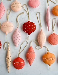 some ornaments are hanging from strings on a table