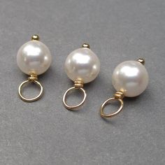 These dangles were created using approx. 6mm White Swarovski pearls. Each pearl has been wire wrapped on a 14k gold fill ball end headpin. Pearl is the birthstone charm for June. This listing is for 3 dangles. MORE PEARLS: https://www.etsy.com/shop/TheDangleDiva?ref=hdr_shop_menu§ion_id=7328420 MORE Dangles and Pendants: http://www.thedanglediva.etsy.com FOLLOW me: www.facebook.com/thedanglediva for new designs and discount coupons INTERCHANGEABLE EARRINGS: https://www.etsy.com/shop/TheDangleDiv Pearl Bangle Bracelet, Charms Collection, Interchangeable Earrings, Pearl Birthstone, Rose Gold Pearl, Necklace Charms, White Pearl Earring, Charms Necklace, Gold Charms