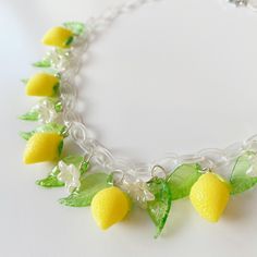 Statement necklaces with dangling bakelite or celluloid charms were extremely popular in the 1940s-50s and often featured flowers, fruit or leaves. This fabulous necklace is designed and handmade by me, inspired by those wild and wacky necklaces of yesteryear. This ooak design features resin lemons, translucent lucite leaves and tiny pearlised blossoms, hanging from a clear plastic chain. The necklace fastens with an authentic vintage style toggle clasp in silver tone metal. Fantasy Necklace, Fruit Jewelry, Statement Necklaces, Toggle Clasp, Jewelry Inspiration, Style Vintage, Charm Necklace, Necklace Etsy, Vintage Style