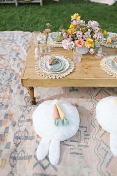 a table set up with plates and flowers on it for a picnic party or brunch