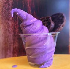 a purple ice cream in a glass on a table