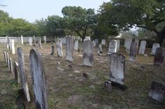 an old cemetery with many headstones and trees