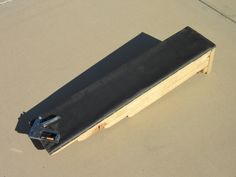 a black bench sitting on top of a sandy beach