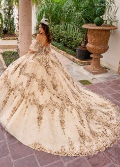 a woman in a wedding dress is standing on a brick walkway with palm trees behind her