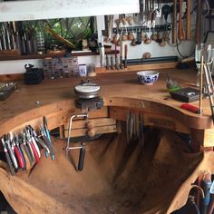 a wooden table topped with lots of tools