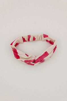 a red and white striped headband on a white background