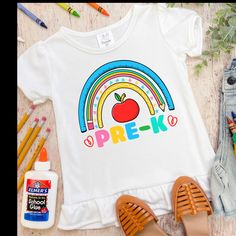 Welcome the beginning of the school year with this cute and vibrant Hello Pre-K shirt.  This shirt would look great paired with jeans or shorts.  These Puff Sleeve t-shirts are high quality, super soft, 100% polyester that feels like soft cotton on the skin. They are printed with eco-friendly ink and will not peel or fade. Please refer to the size chart in the photo gallery section when making your selection.  PROCESSING TME: Processing time is currently 1-3 business days from date of purchase a Playful Multicolor Shirt For School, Cute Multicolor School Shirt, Rainbow Tee, School Glue, Beginning Of The School Year, Girls Shirt, First Day Of School, Kids Tops, School Year