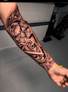 a man's arm with a clock tattoo on it