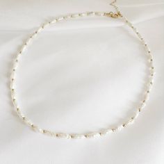 Genuine AA freshwater rice pearls & high quality 14k gold filled beads and finishes; adjustable. Length: 16” + 2” gold filled extender Genuine 3-4mm freshwater pearls Lobster clasp Each natural pearl is unique and therefore no two are alike. Pearl, colors and sizes may vary. Handmade with the highest standards & quality materials. * PEARL CARE TIPS Here's what we recommend: 1) Always keep pearls safe as they can scratch easily 2) Avoid water and chemicals as they can eat away the nacre of the pe White Single Strand Pearl Necklace With 14k Gold Filled, White Single Strand Pearl Necklace In 14k Gold, Adjustable Pearl Necklace With Gold Beads As Gift, Adjustable White Pearl Necklace With 14k Gold Filled, Adjustable White Pearl Necklace In 14k Gold Filled, Adjustable Gold Beaded Necklace With Baroque Pearls, Adjustable Pearl Necklace With Gold Beads, Adjustable Gold Baroque Pearl Beaded Necklace, Adjustable Gold Beaded Necklace With Pearl Charm