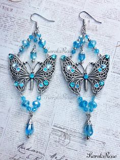 "These Handmade Sparkly Crystal Butterfly Chandelier Earrings are made with crystal beads and plated metal butterflies. Hand-set Swarovski rhinestones add an intense sparkle! ...truly magical! Available with French Wires, Posts or Clip-Ons. -5\" Long x 2\" Wide -0.4 oz. ea. -Many Colors Available in the pull-down menu! Metal Finishes Available: -Silver -Bronze *Comes Ready To Gift in Decorative Packaging *Each Pair is Made Just for You! Kerala Rose Pinterest page: https://www.pinterest.com/keral Crystal Jeweled Chandelier Earrings Gift, Nickel-free Butterfly Jewelry For Party, Party Jewelry With Butterfly Dangle Charm, Crystal Butterfly Charm Jewelry, Crystal Jewelry With Butterfly Charm, Butterfly Shaped Beaded Jewelry For Party, Bohemian Butterfly Jewelry For Parties, Metal Butterflies, Butterfly Chandeliers