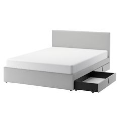 a bed with two drawers underneath it and an open drawer on the bottom half of the bed